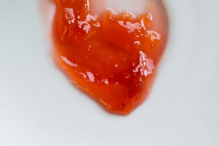 Plum jam gel test showing jam that has gelled and is ready for canning
